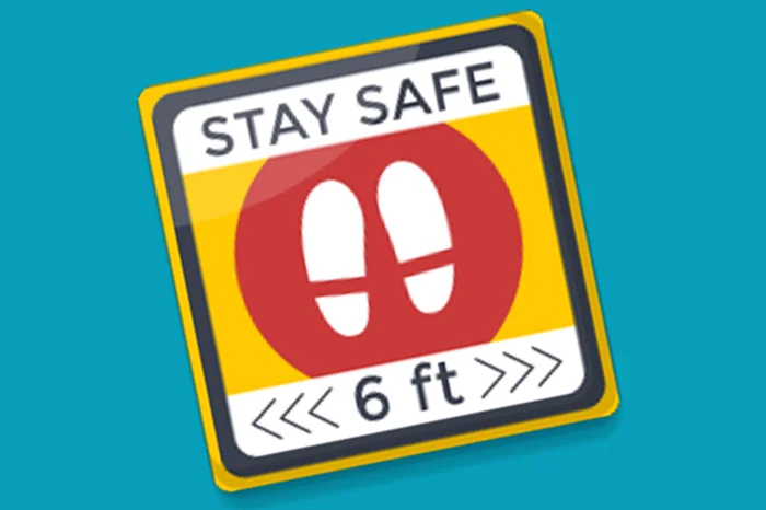 Floor decal with a safety message and six-foot spacing reminder